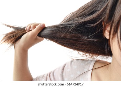Young woman pulling her hair 