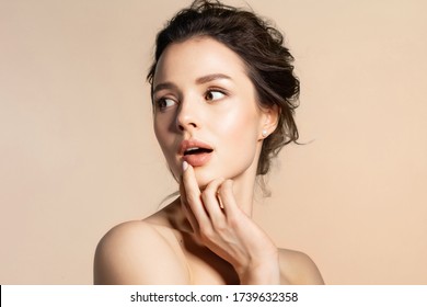 Young Woman With Pure Skin Feeling Fear, Wonder, Surprise Or Shock Beauty Portrait On Beige Copy Space. Pretty Millennial Girl With Bare Shoulder Open Mouth. 