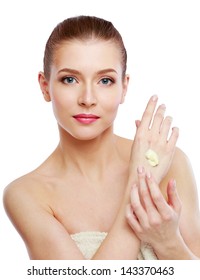 Young Woman Putting Cream On Her Hand Isolated On White Background