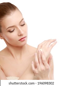 Young Woman Putting Cream On Her Hand Isolated On White Background