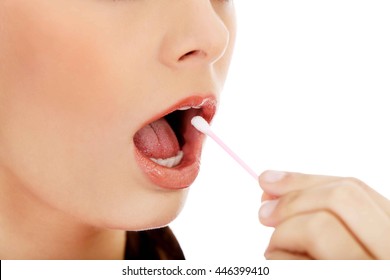 Young Woman Putting Ear Stick Into Mouth