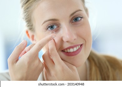 Young Woman Putting Eye Contact Lense On