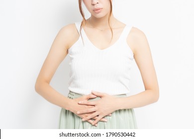 Young woman putting her hand on her stomach