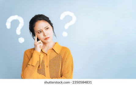 Young woman with question marks. - Powered by Shutterstock