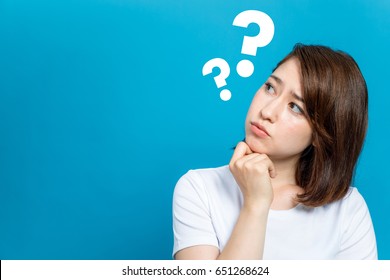 young woman with question marks. - Shutterstock ID 651268624