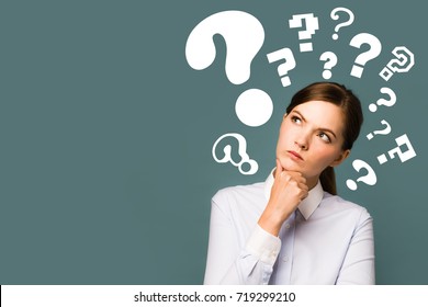 young woman with question marks. - Shutterstock ID 719299210