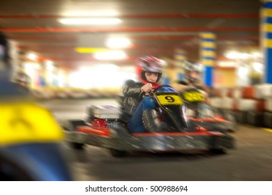 Young Woman Racing On Go Cart Track