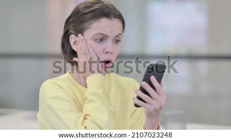 Young Woman Reacting to Loss on Smartphone