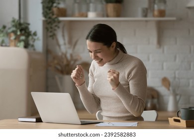 Young woman read e-mail with great news on laptop feels happy, got notice about university scholarship or admission, got special commercial offer, celebrate on-line auction victory, triumph concept - Powered by Shutterstock