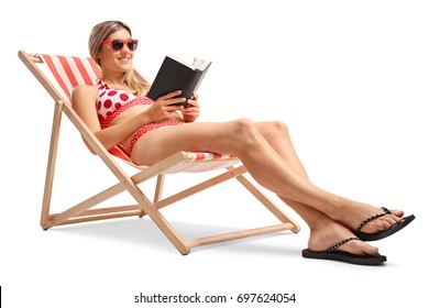 Young Woman Reading A Book In A Deck Chair Isolated On White Background