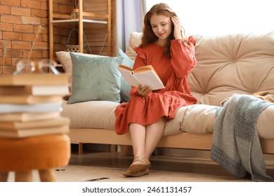 Young woman reading book at home - Powered by Shutterstock