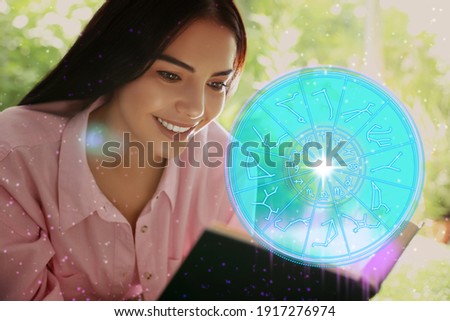 Young woman reading book outdoors and illustration of zodiac wheel with astrological signs