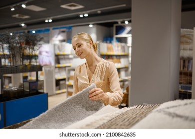 Young Woman Reading Catalog With Furniture Material