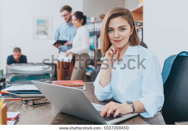 Young woman reading\
email at the office