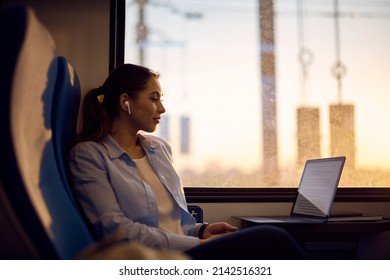 Young Woman Reading An E-mail On Laptop While Commuting To Work By Train. 