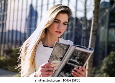 Young Woman Reading A Magazine
