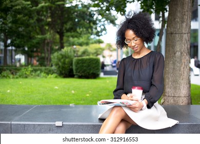 Young Woman Reading A Magazine With A Coffee