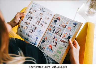 Young Woman Reading Manga Comic Book At Home. Rostov-on-Don, Russia - April 25 2022