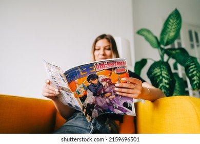 Young Woman Reading Manga Comic Book At Home. Rostov-on-Don, Russia - April 25 2022