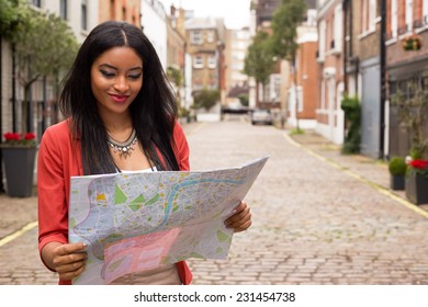 young woman reading a map - Shutterstock ID 231454738
