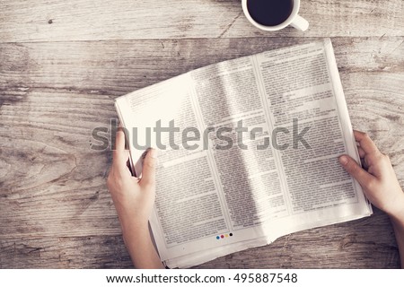 Young woman reading newspaper
