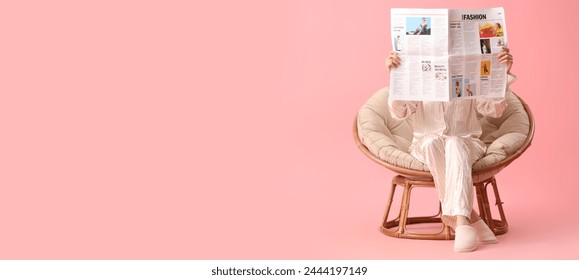 Young woman reading newspaper in armchair on pink background with space for text - Powered by Shutterstock