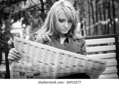 woman reading newspaper black and white