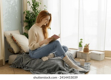 Young woman reading notebook at home - Powered by Shutterstock