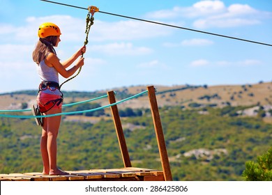 Young Woman Are Ready To Descend On Zipline In Mountain, Extreme Sport