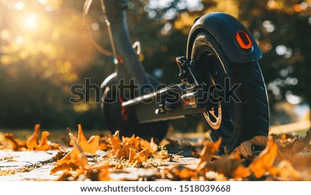 Young woman is ready to discover the urban city in autumn at sunset with electric scooter or e-scooter, Electric urban transportation concept image