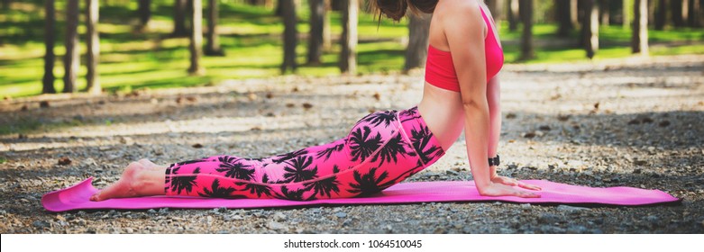 Young woman ready to practicing yoga in a forest. Upward Facing Dog Pose. Calmness, relax, mind and body web banner.