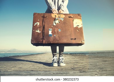 young woman ready to travel with her suitcase - Powered by Shutterstock