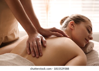 Young Woman Receiving Back Massage In Spa Salon