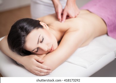 Young Woman Receiving Back Massage At Spa