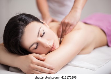 Young Woman Receiving Back Massage At Spa