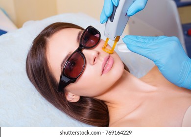 Young Woman Receiving Epilation Laser Treatment On Face At Beauty Center Close Up