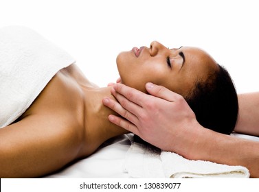 young woman receiving facial massage with closed eyes in a spa salon