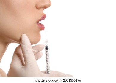 Young Woman Receiving Filler Injection In Lips Against White Background, Closeup