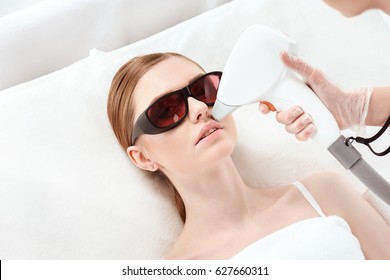 Young Woman Receiving Laser Hair Removal Epilation On Face. Laser Skin Care Concept