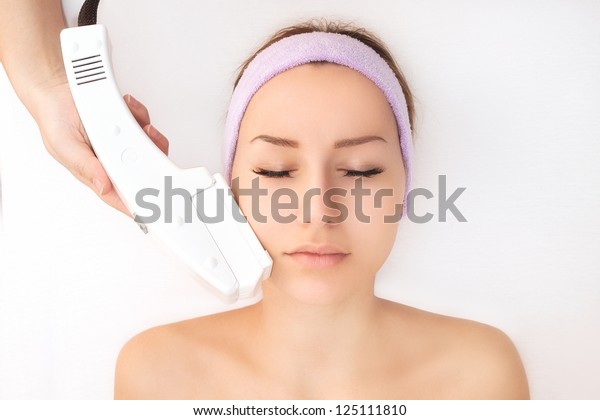 Young woman receiving\
laser treatment