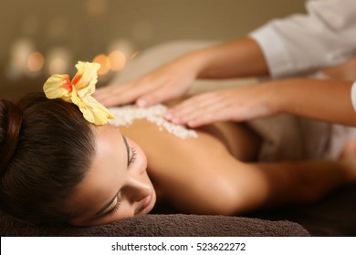 Young Woman Receiving Salt Massage In Spa Salon