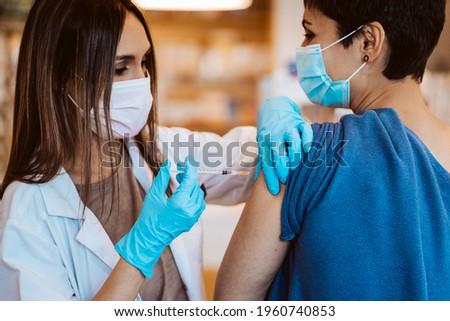Young woman receiving the vaccine for the virus caused by covid 19. Immunization of the population. Fight against the virus