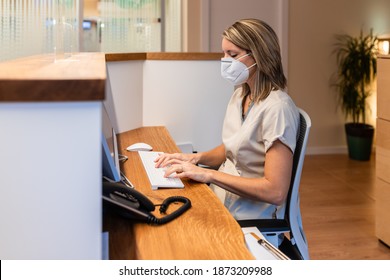 Young Woman At The Reception Of Fitness Club Or Health Centre With Mask