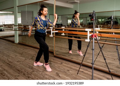 Young Woman Recording On Camera A Dance Lesson In A Choreography Hall With Mirrors.