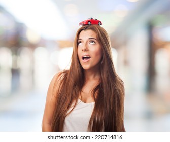 Young Woman With A Red Car Over His Head