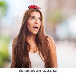 Young Woman With A Red Car Over His Head