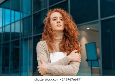 Young Woman With Red Curly Hair Standing Outside Modern Building - Powered by Shutterstock