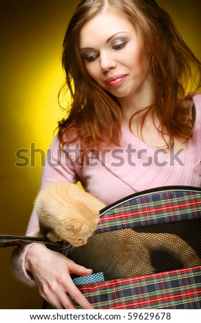 Young woman with red England lop-eared kitten
