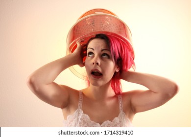 Young Woman With Red Hair Sitting Under A Hood Hair Dryer