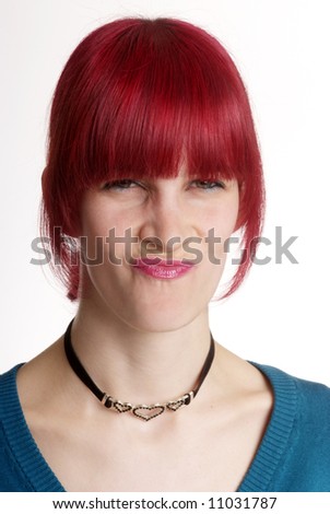 a young woman with red hair turns nose
